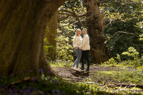 Pre-wedding shoot at Mapperley Reservoir's woodland area with Tia and Kieran holding each other with a huge oak framing the scene. John Fox: wedding photographer covering Nottinghamshire
