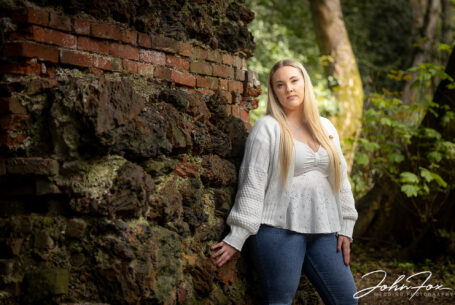 Pre-wedding shoot at Mapperley Reservoir's woodland area with Tia, the bride to be, by a textured wall. John Fox: wedding photographer covering Nottinghamshire