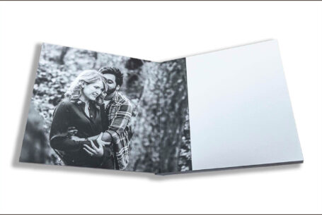 Isobel and Roshan’s Guest Book images. The couple holding each other amongst the trees. Wedding photographer in Rugby Warwickshire John Fox.