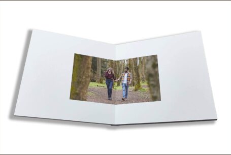 Isobel and Roshan’s Guest Book images. The couple walking together in woodland on their pre-wedding shoot in Rugby, Warwickshire.