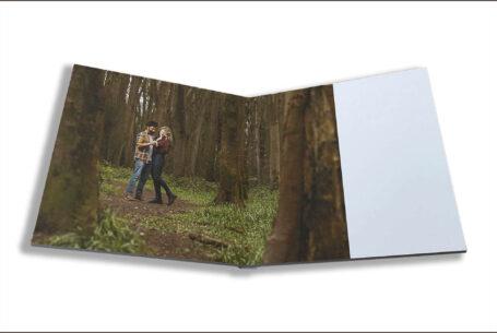 Isobel and Roshan’s Guest Book images. The couple together and framed by trees on their pre-wedding shoot in Rugby, Warwickshire