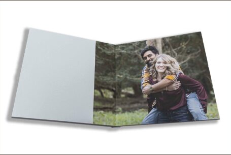 Isobel and Roshan’s Guest Book images with the bride-to-be giving the groom-to-be a piggyback. Pre-wedding shoot in Rugby, Warwickshire